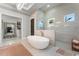 Modern bathroom with freestanding tub, walk-in shower, and double sinks at 3167 Whisper Wind Dr, St Cloud, FL 34771