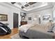 Bright main bedroom with hardwood floors, king-size bed, and ensuite access at 3167 Whisper Wind Dr, St Cloud, FL 34771
