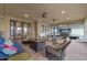 Spacious screened patio with outdoor furniture, fire pit, dining area, and grill at 3305 Cat Brier Trl, Harmony, FL 34773