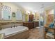 Primary bathroom featuring dual vanities, a soaking tub, and tiled floors at 3305 Cat Brier Trl, Harmony, FL 34773