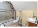 Clean and bright bathroom featuring tiled shower, white fixtures, and wood vanity at 3305 Cat Brier Trl, Harmony, FL 34773