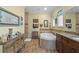 Large bathroom with dual vanity, a jetted tub, and tiled floors at 3305 Cat Brier Trl, Harmony, FL 34773