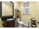 Bathroom with dark wood vanity, single sink, and decorative shelving at 3305 Cat Brier Trl, Harmony, FL 34773