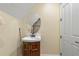 Small bathroom with pedestal sink, oval mirror, and wood vanity at 3305 Cat Brier Trl, Harmony, FL 34773