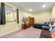 Bedroom with twin bed, brown couch, and built-in shelves at 3305 Cat Brier Trl, Harmony, FL 34773