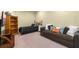 Bedroom with twin bed, brown sofa, and wooden bookcase at 3305 Cat Brier Trl, Harmony, FL 34773