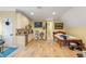 Bonus room with kitchenette, twin bed, and hardwood floors at 3305 Cat Brier Trl, Harmony, FL 34773