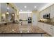 Bright kitchen boasts white cabinets, granite counters, and stainless steel appliances at 3305 Cat Brier Trl, Harmony, FL 34773