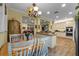 Eat-in kitchen with white cabinetry, granite countertops, and stainless steel appliances at 3305 Cat Brier Trl, Harmony, FL 34773