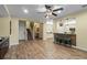 Spacious living area features wood-look tile floors, a breakfast bar, and a view of the staircase at 3305 Cat Brier Trl, Harmony, FL 34773