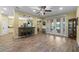 Open-concept living area with wood-look tile floors, breakfast bar, and access to backyard at 3305 Cat Brier Trl, Harmony, FL 34773