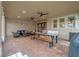 Covered patio with outdoor dining table, seating area, ceiling fans, and string lights at 3305 Cat Brier Trl, Harmony, FL 34773