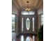 Bright entryway with hardwood floors and a chandelier at 3900 County Road 557A, Polk City, FL 33868