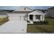 One-story house with solar panels and a two-car garage, aerial view at 420 Watusi Way, St Cloud, FL 34772