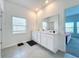 Bright bathroom with double vanity and gray tile floor at 420 Watusi Way, St Cloud, FL 34772