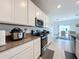 Modern kitchen with stainless steel appliances and white cabinets at 420 Watusi Way, St Cloud, FL 34772