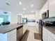 Modern kitchen with island and stainless steel appliances at 420 Watusi Way, St Cloud, FL 34772