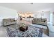 Open concept living room with kitchen view and area rug at 420 Watusi Way, St Cloud, FL 34772