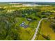 Aerial view of property with house, detached garage, and surrounding fields at 5155 Haywood Ruffin Rd, Saint Cloud, FL 34771