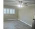 Bedroom with ceiling fan and large window with window shutters at 5411 Ira St, Orlando, FL 32807