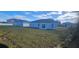 Large backyard with other houses visible in the background at 605 Raven Ct, Kissimmee, FL 34759