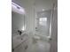 Clean bathroom with single vanity, tub, and marble floors at 605 Raven Ct, Kissimmee, FL 34759