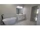 Elegant bathroom featuring a freestanding tub and double vanity at 605 Raven Ct, Kissimmee, FL 34759