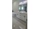 Modern bathroom with double vanity, soaking tub, and marble floors at 605 Raven Ct, Kissimmee, FL 34759