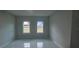 Bright bedroom with two large windows and white walls at 605 Raven Ct, Kissimmee, FL 34759