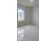 Bright bedroom with a window and marble-style floors at 605 Raven Ct, Kissimmee, FL 34759