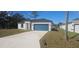 Newly built home with a teal garage door and concrete driveway at 605 Raven Ct, Kissimmee, FL 34759