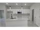 Modern kitchen with white cabinets and quartz countertops at 605 Raven Ct, Kissimmee, FL 34759