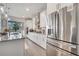 Stainless steel appliances and white cabinets in a modern kitchen at 629 Big Pine Ave, Minneola, FL 34715