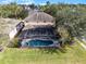 Aerial view showing home, pool, and lush backyard at 673 Copeland Dr, Haines City, FL 33844