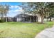 Landscaped backyard with screened pool and patio at 673 Copeland Dr, Haines City, FL 33844