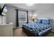 Guest bedroom with a queen-size bed and large window at 673 Copeland Dr, Haines City, FL 33844