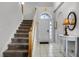 Entryway with staircase, tiled floor, and small table with lamp at 673 Copeland Dr, Haines City, FL 33844