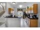Kitchen with light wood cabinets, black countertops, and stainless steel appliances at 673 Copeland Dr, Haines City, FL 33844