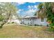 Gray house with white trim and a well-maintained lawn at 723 Florida Pkwy, Kissimmee, FL 34743