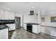 Modern kitchen with island, white cabinets, and granite countertops at 723 Florida Pkwy, Kissimmee, FL 34743