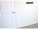 Simple bedroom with white walls, carpet, and a door at 1366 Yellow Finch Dr, Davenport, FL 33837