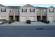 Three-unit townhome building with attached garages and landscaping at 1366 Yellow Finch Dr, Davenport, FL 33837