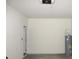 Garage interior with water heater and door to house at 1366 Yellow Finch Dr, Davenport, FL 33837