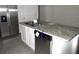 Kitchen island with granite countertop and stainless steel dishwasher at 1366 Yellow Finch Dr, Davenport, FL 33837