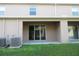 Back patio with access to the house and a grassy yard at 1366 Yellow Finch Dr, Davenport, FL 33837
