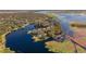 Aerial view of lakefront property with lush vegetation at 1465 Riviera Dr, Kissimmee, FL 34744
