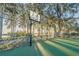 Outdoor basketball court with green surface and chain link fence at 1465 Riviera Dr, Kissimmee, FL 34744