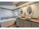 Spa-like bathroom with double sinks, a soaking tub, and a walk-in shower at 1465 Riviera Dr, Kissimmee, FL 34744