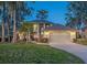 Two-story house with a large yard, attached garage, and a charming front entrance at 1465 Riviera Dr, Kissimmee, FL 34744