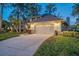 Two-story home with attached garage and landscaped yard at 1465 Riviera Dr, Kissimmee, FL 34744